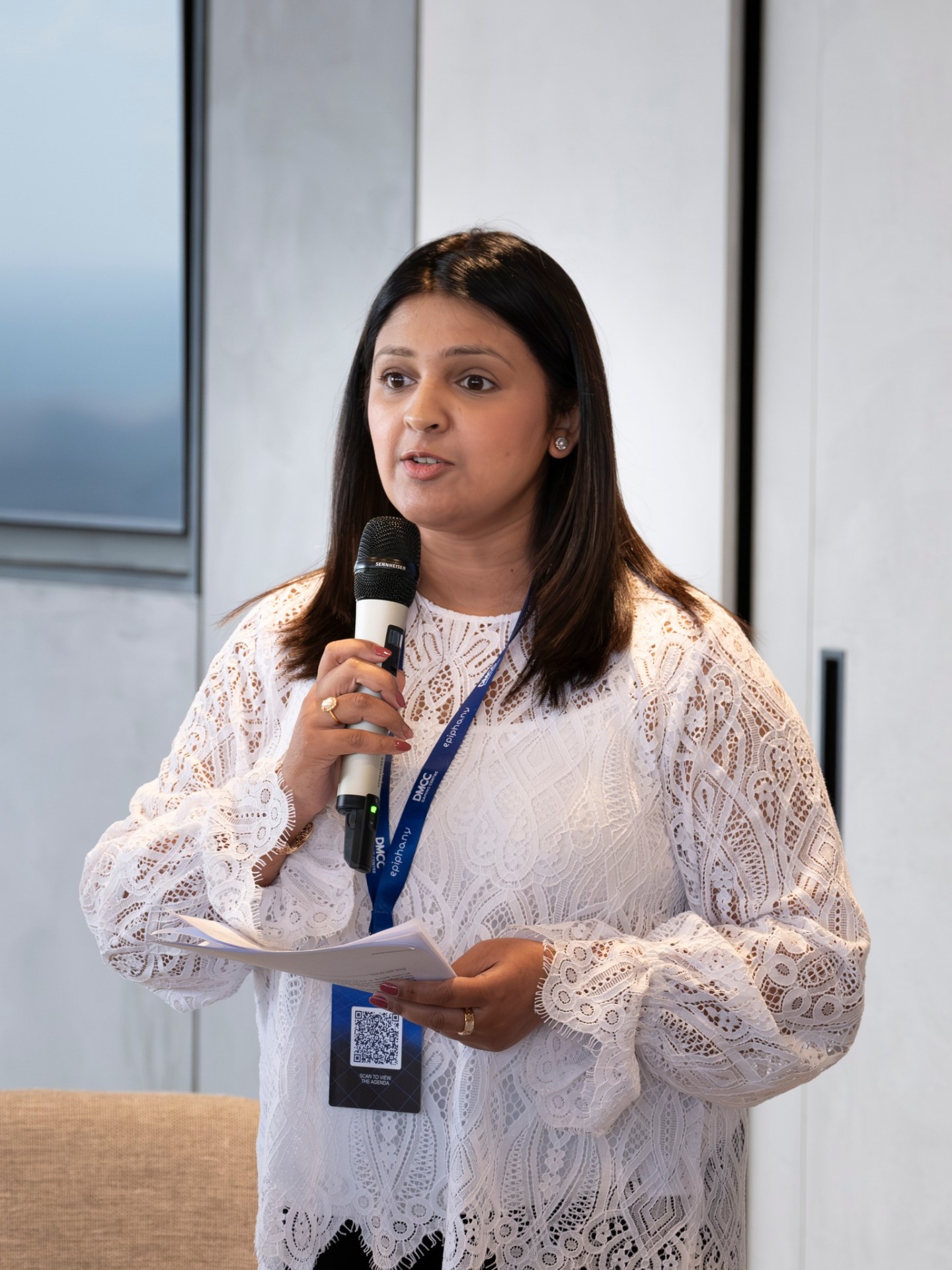 Samar speaking with a microphone at the Global Capital Confluence in Dubai